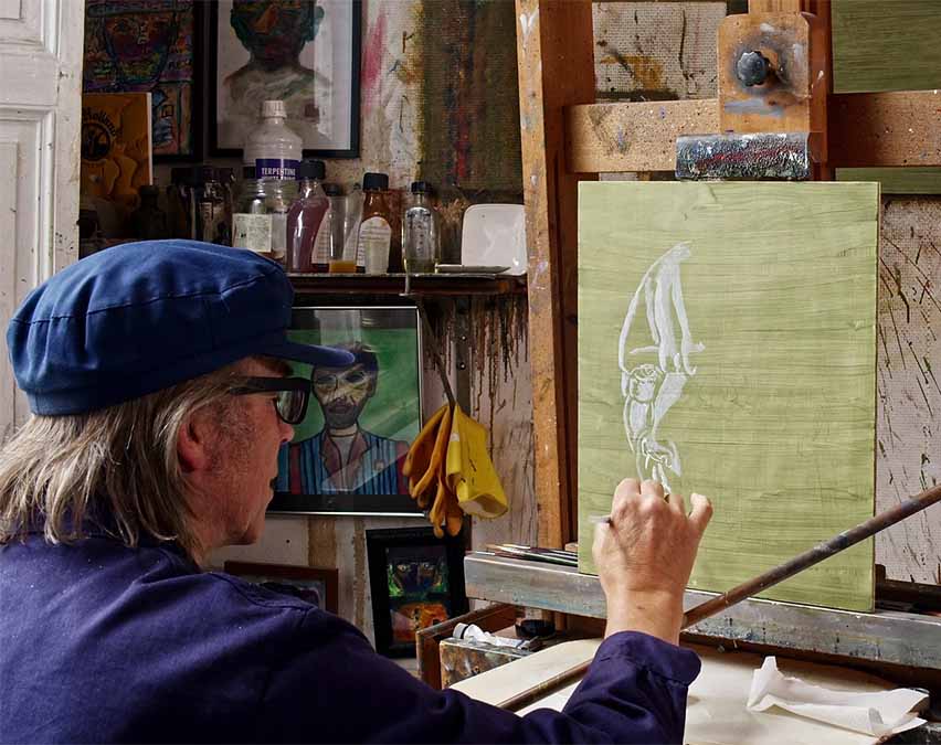 Philip Akkerman seen from behind while painting